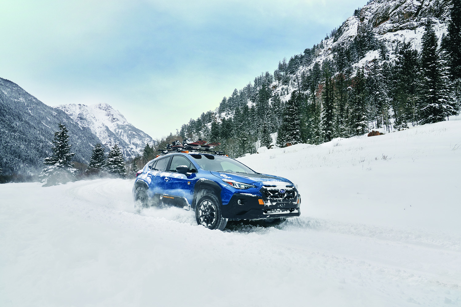 A 2026 Subaru Outback Wilderness driving through thick snow.