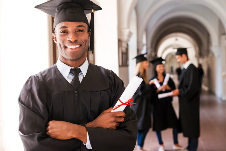 college graduate holding his diploma | Frederick Subaru in Frederick MD