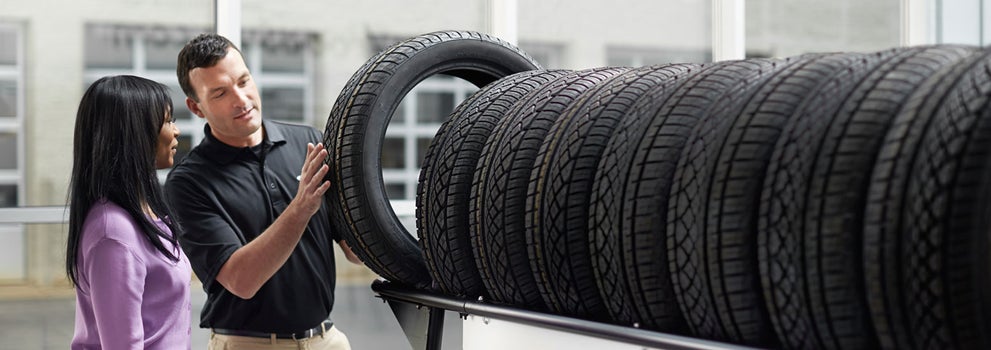 Subaru service representative showing customer a tire. | Frederick Subaru in Frederick MD